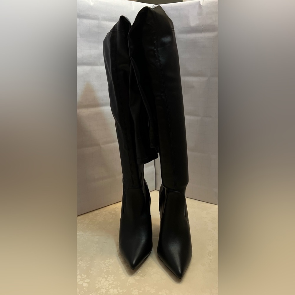 Patent leather design thigh high with a 4” heel made with a stretchable fabric.
